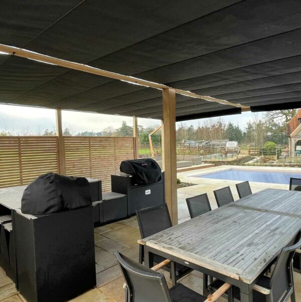 oak pergola with twin retraceable shade and outdoor kitchen